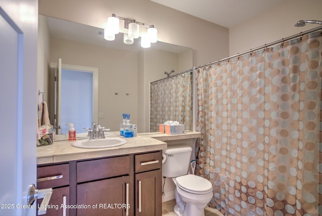 bathroom featuring vanity, tile patterned flooring, curtained shower, and toilet