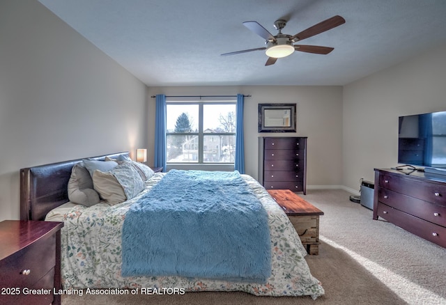 bedroom featuring ceiling fan and light carpet