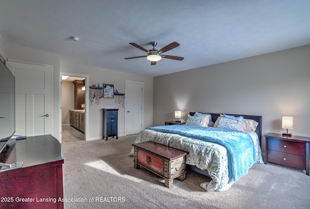 bedroom featuring connected bathroom, light carpet, and ceiling fan