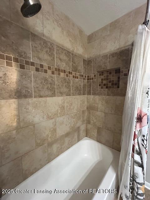 bathroom with shower / bath combination with curtain