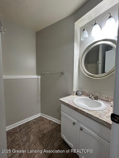 bathroom with vanity and a textured ceiling