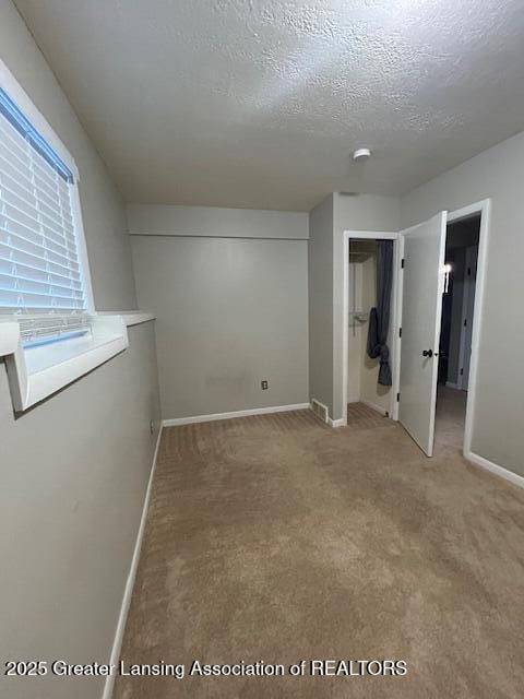 unfurnished bedroom with a closet, a textured ceiling, and carpet flooring