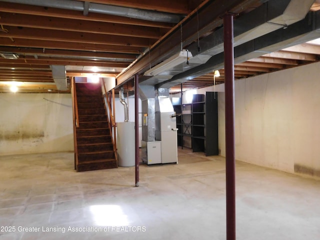 basement featuring gas water heater and heating unit