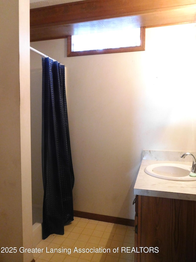 bathroom with vanity and curtained shower