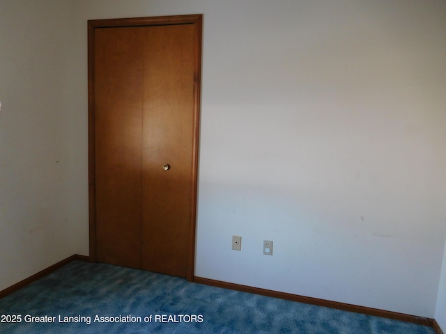 unfurnished bedroom with a closet and carpet