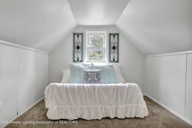 carpeted bedroom with lofted ceiling