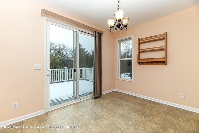 spare room with a notable chandelier