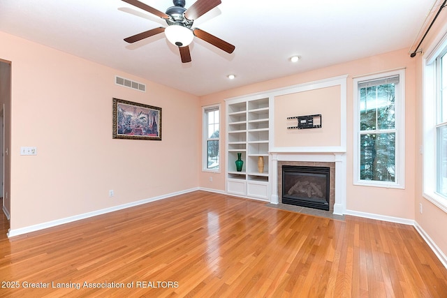 unfurnished living room with ceiling fan and light hardwood / wood-style floors