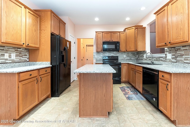 kitchen featuring sink, backsplash, light stone counters, black appliances, and a kitchen island