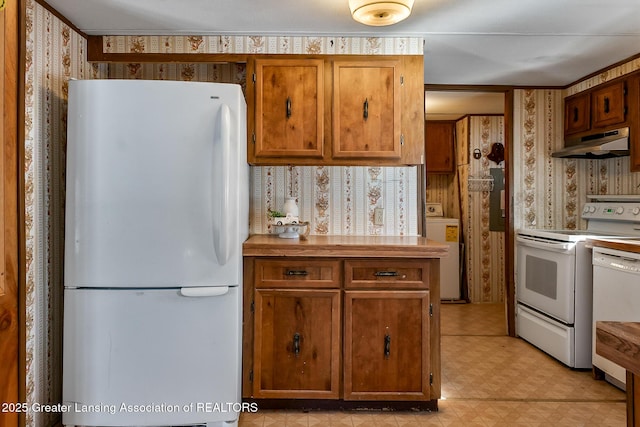 kitchen featuring washer / clothes dryer and white appliances