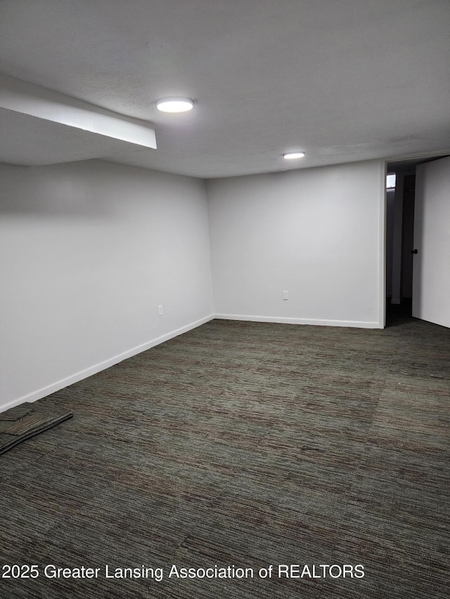 basement featuring dark colored carpet