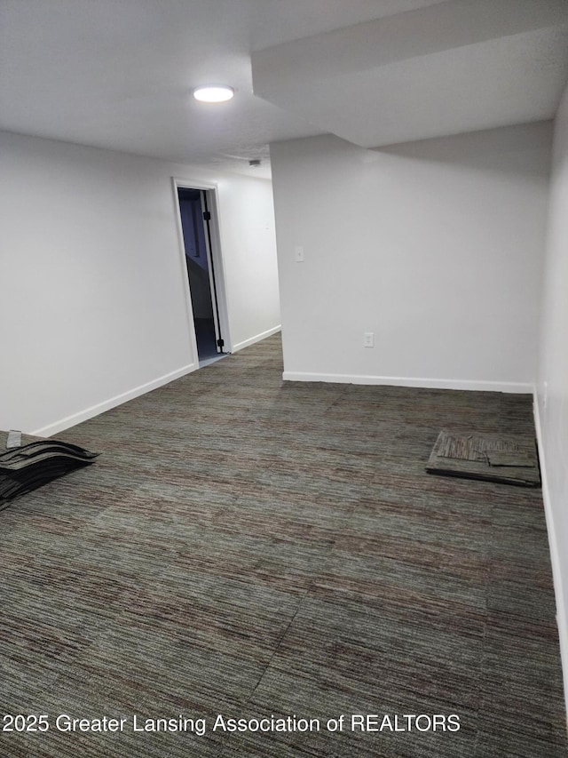 basement featuring dark carpet