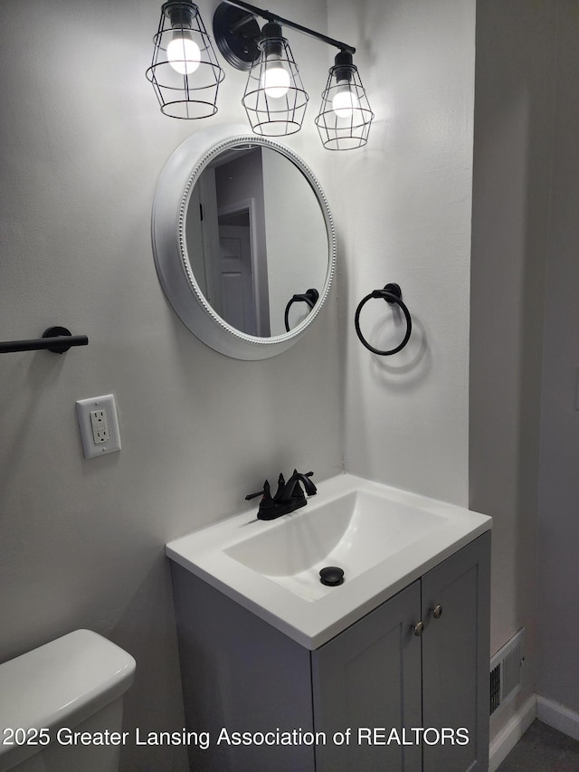 bathroom with vanity and toilet