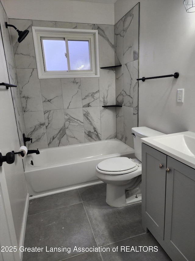 full bathroom featuring tiled shower / bath, vanity, and toilet