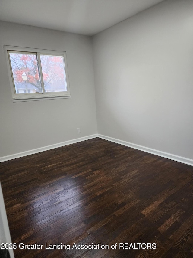 unfurnished room with dark hardwood / wood-style floors