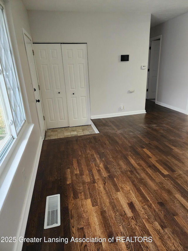 spare room featuring dark hardwood / wood-style floors