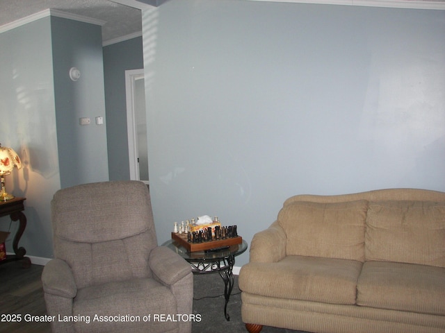 living room featuring wood-type flooring and ornamental molding