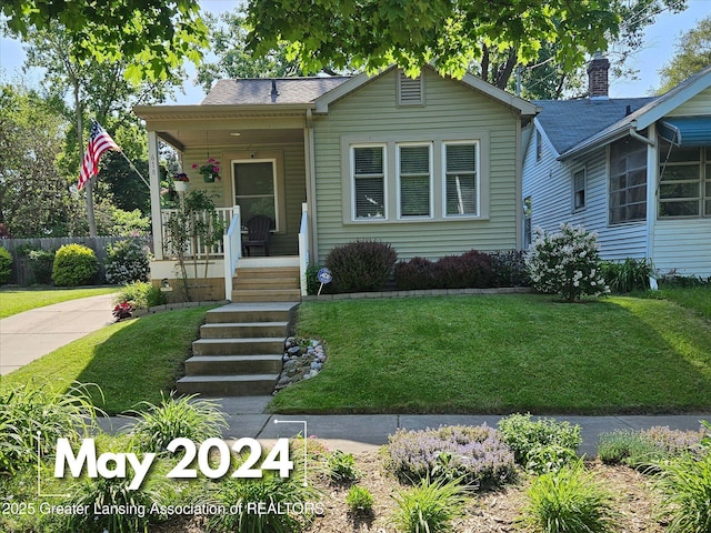 view of front of house with a front lawn and covered porch