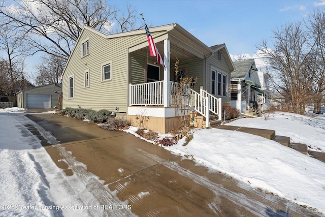 view of front facade with a garage, an outdoor structure, and covered porch