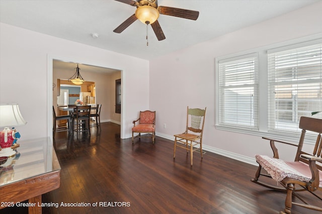 sitting room featuring ceiling fan and dark hardwood / wood-style flooring