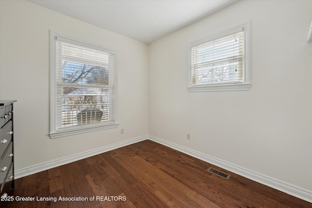 unfurnished room with hardwood / wood-style flooring and plenty of natural light