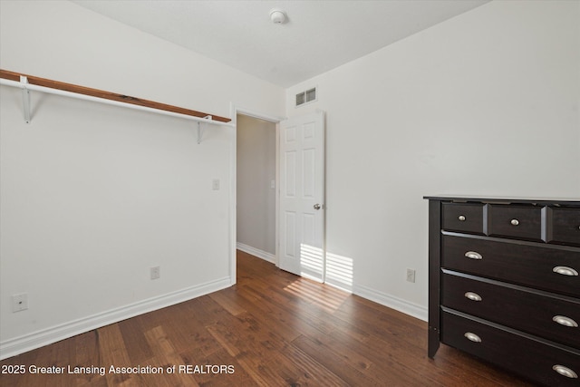 unfurnished bedroom featuring dark wood-type flooring