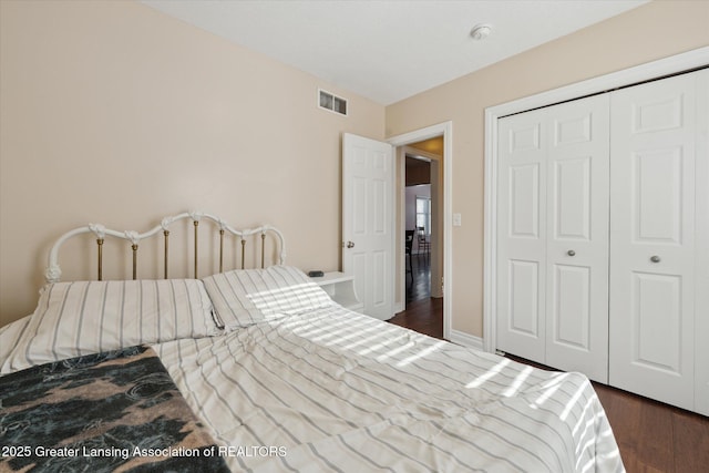 bedroom featuring dark hardwood / wood-style flooring and a closet