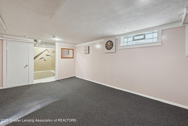 basement featuring carpet floors and a textured ceiling