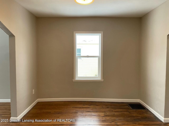 spare room with dark hardwood / wood-style flooring