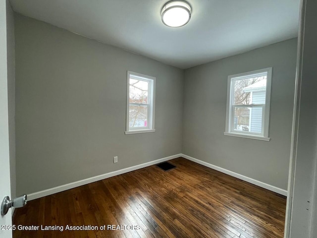 spare room featuring dark hardwood / wood-style floors