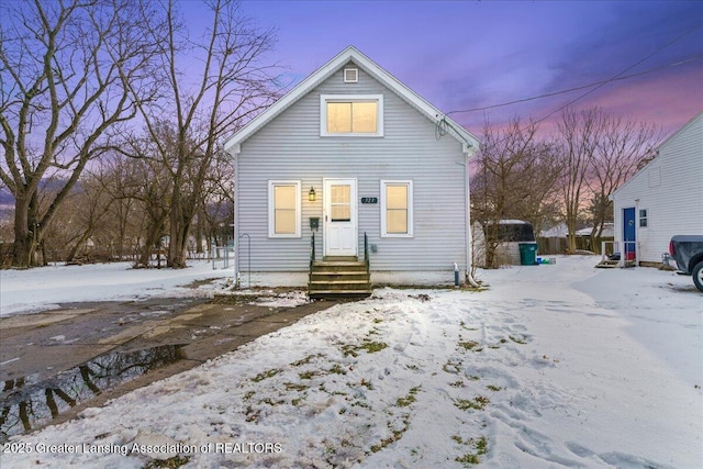 view of snow covered rear of property