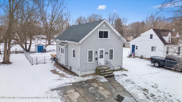 bungalow featuring a shed