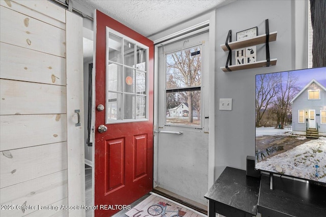 entryway featuring a textured ceiling