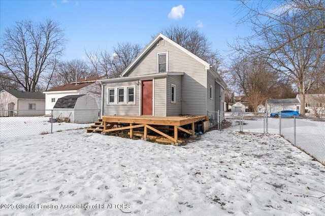 view of snow covered rear of property