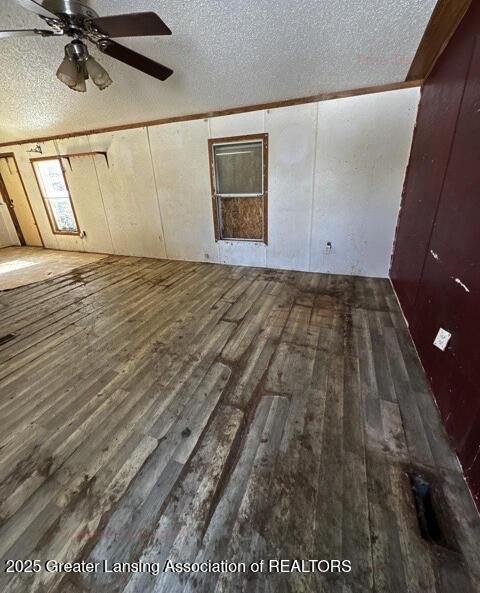 bonus room featuring ceiling fan, dark hardwood / wood-style floors, and a textured ceiling