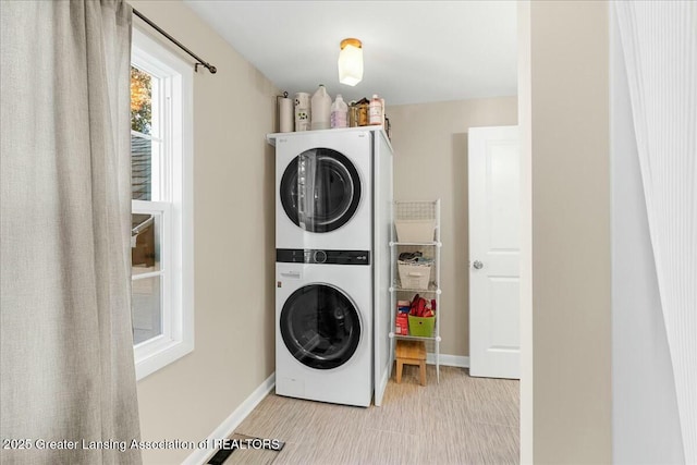 washroom with stacked washer and dryer