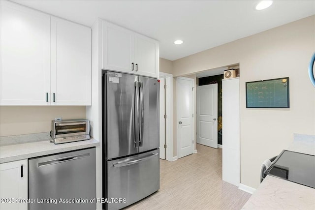 kitchen featuring white cabinetry and appliances with stainless steel finishes