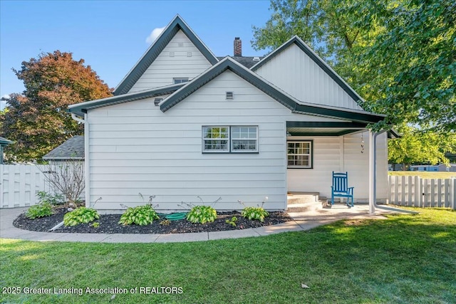 rear view of house with a yard