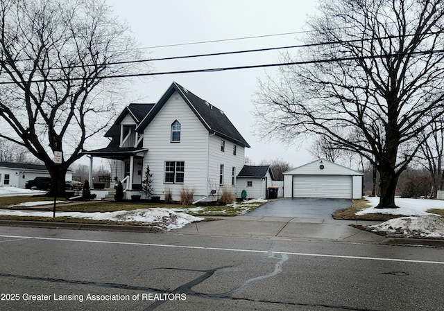 view of front facade with a garage and an outbuilding