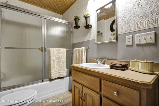 full bathroom featuring crown molding, bath / shower combo with glass door, vanity, tile patterned floors, and toilet