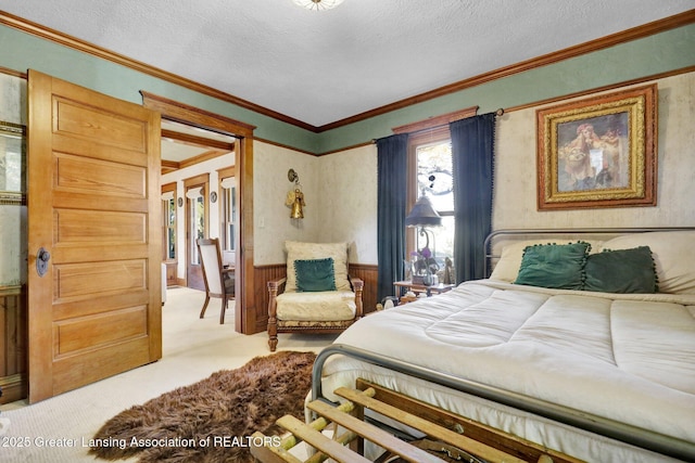 carpeted bedroom with crown molding and a textured ceiling