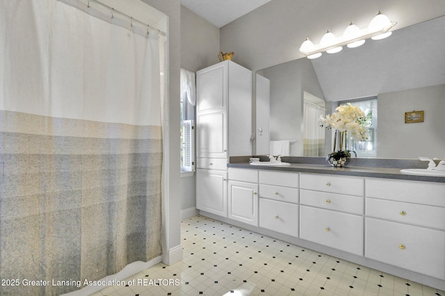 bathroom featuring vanity and vaulted ceiling