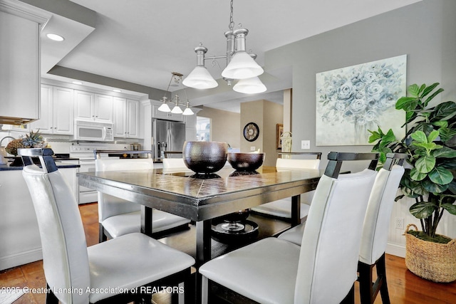 dining space with hardwood / wood-style flooring