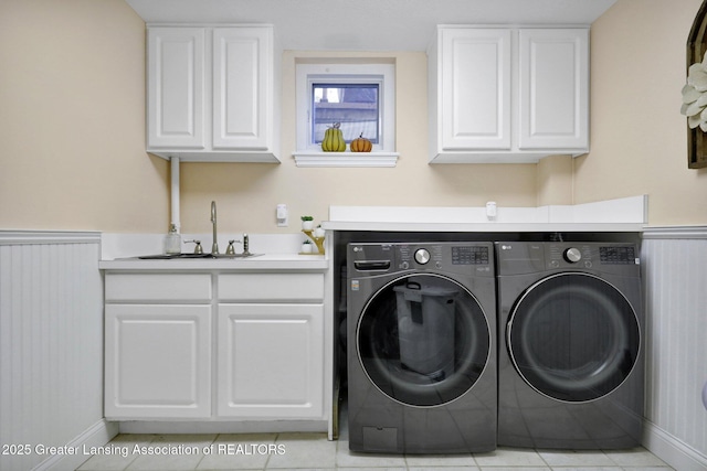 laundry room with sink, cabinets, and washing machine and clothes dryer