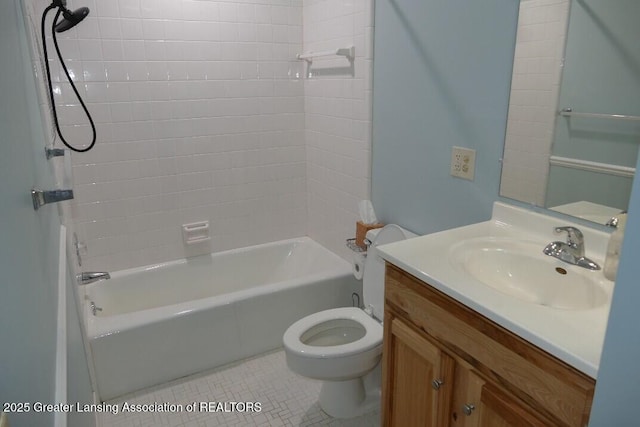 full bathroom with tile patterned flooring, vanity, tiled shower / bath, and toilet