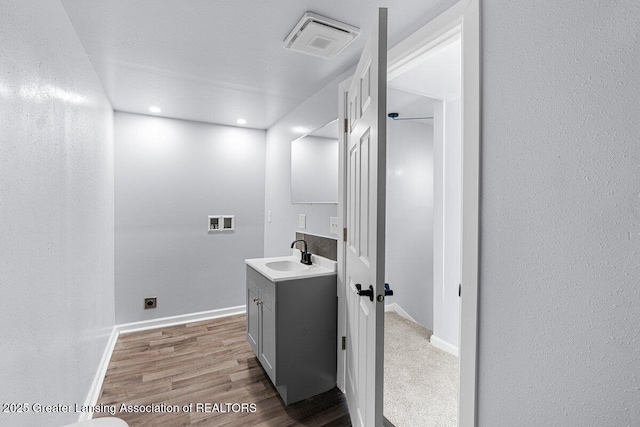 bathroom with vanity and wood-type flooring