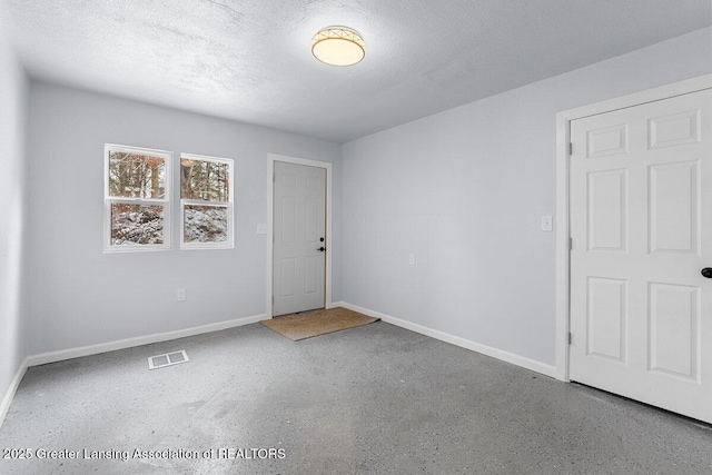 empty room featuring a textured ceiling