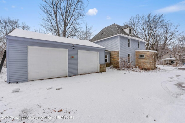 exterior space with a garage and an outdoor structure