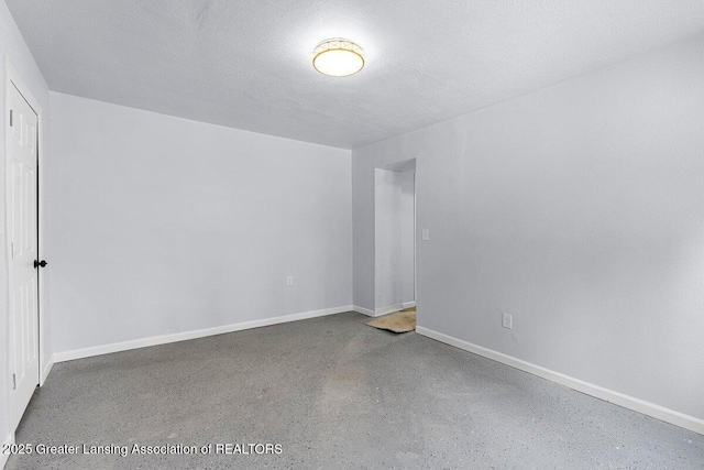 spare room with a textured ceiling