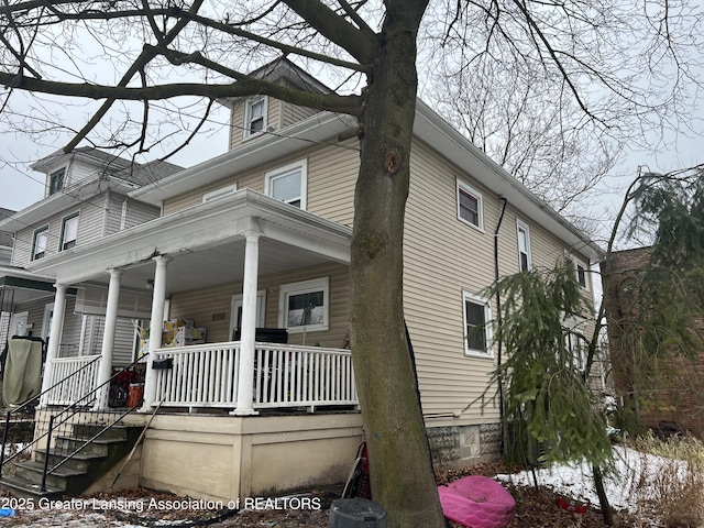 view of property exterior with covered porch